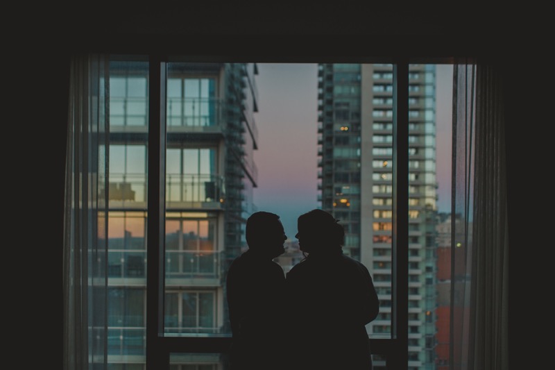 The two of us in silhouette, standing in front of a hotel window looking out at the city