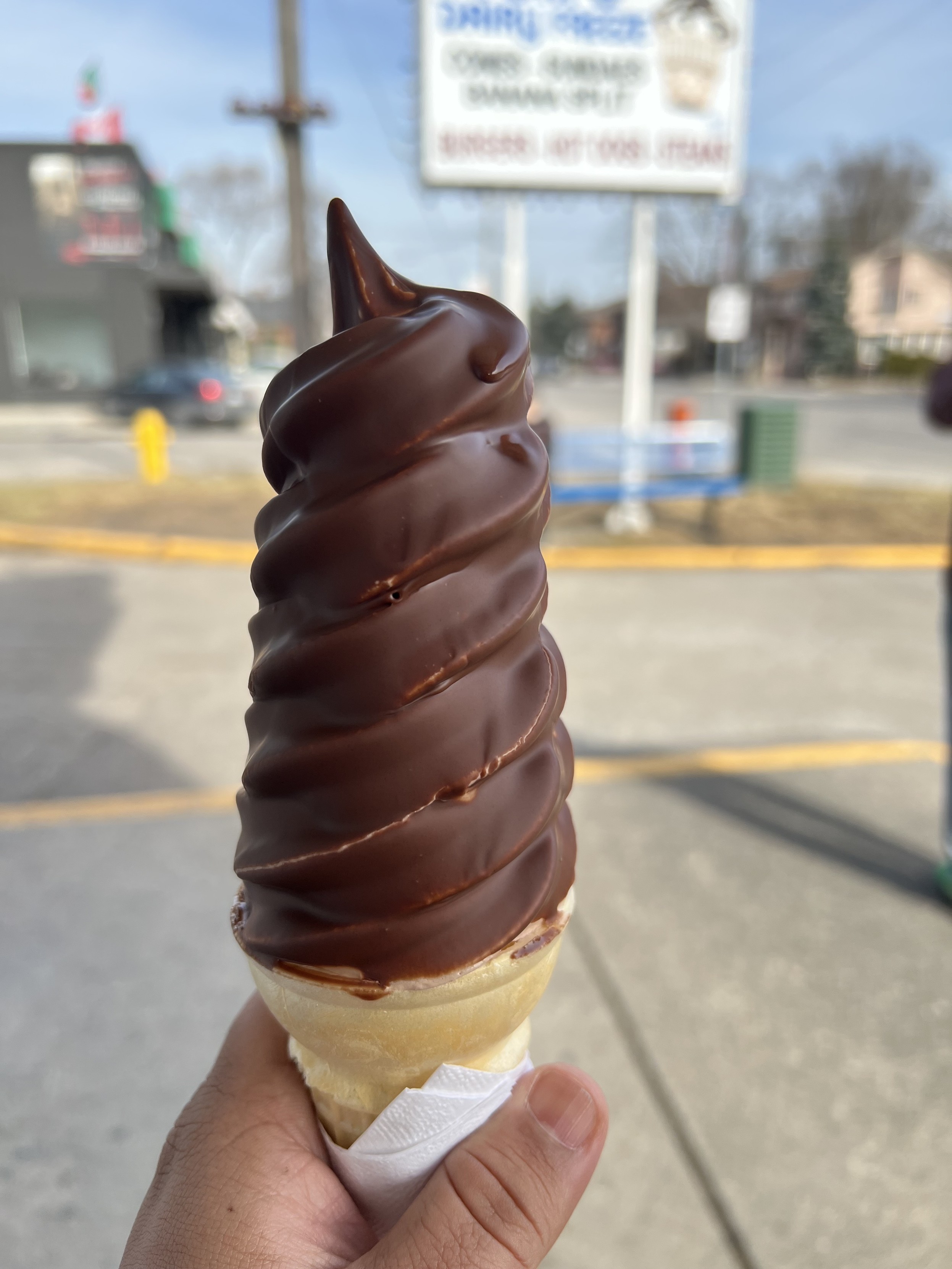 Photo of chocolate dipped soft serve ice cream cone